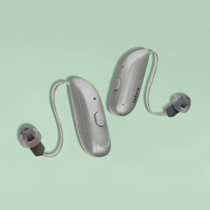 Enhance Select 300 hearing aids on green background
