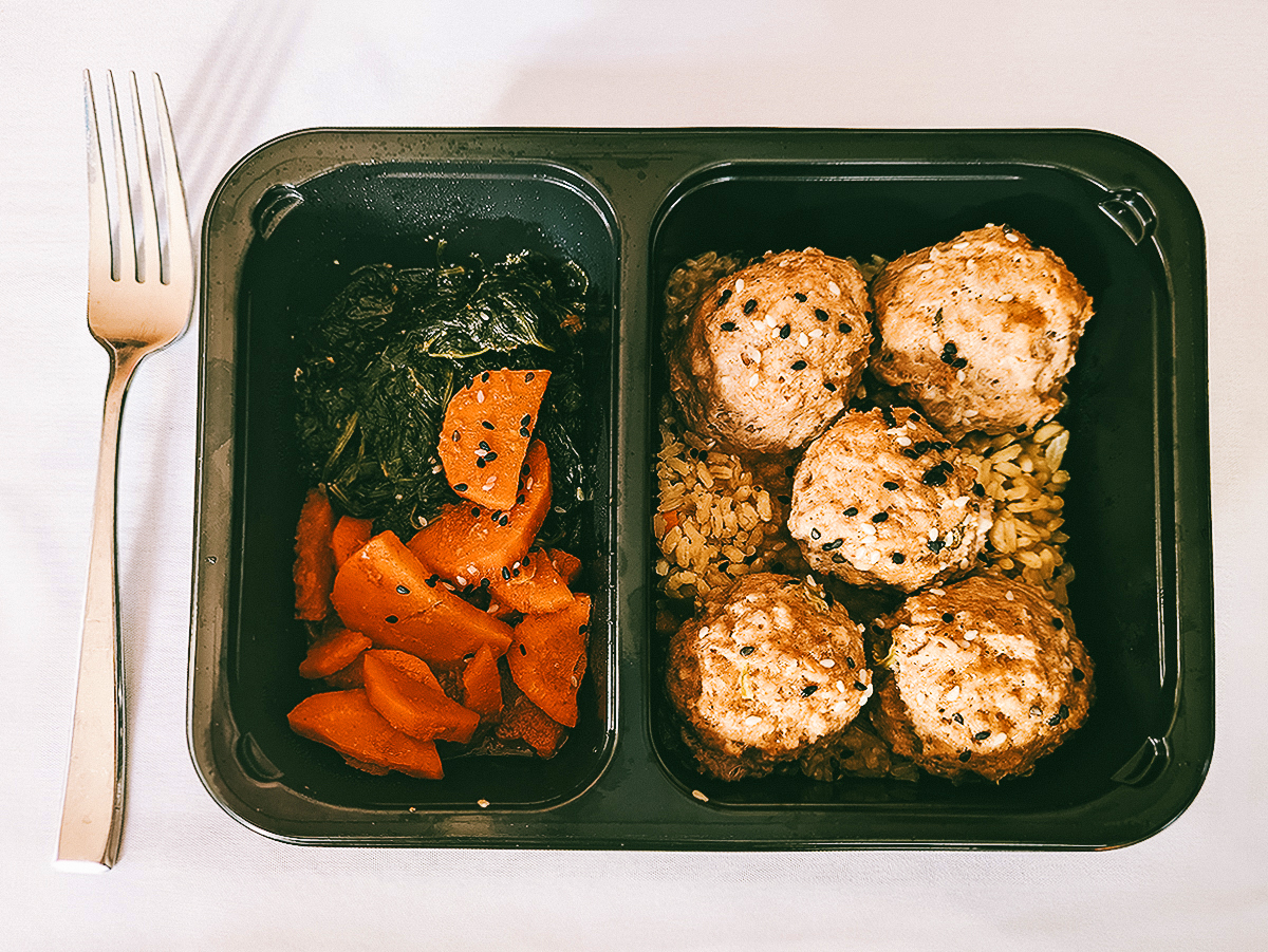 Asian meatballs over brown rice with sesame spinach and carrots