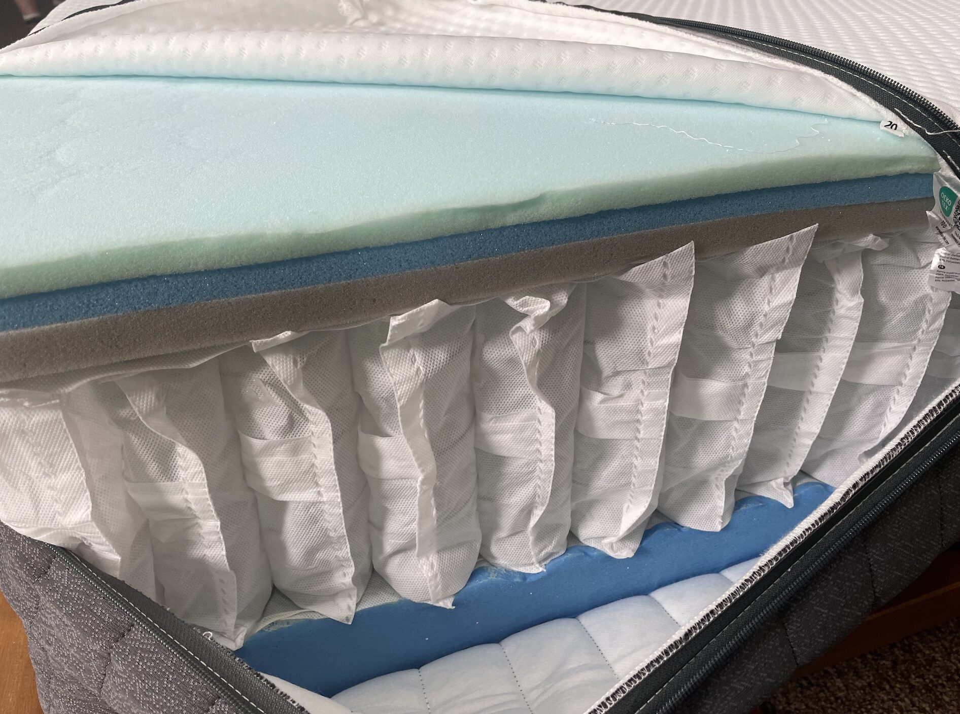  Inside view of an Emma Hybrid mattress showing coils and foam layers
