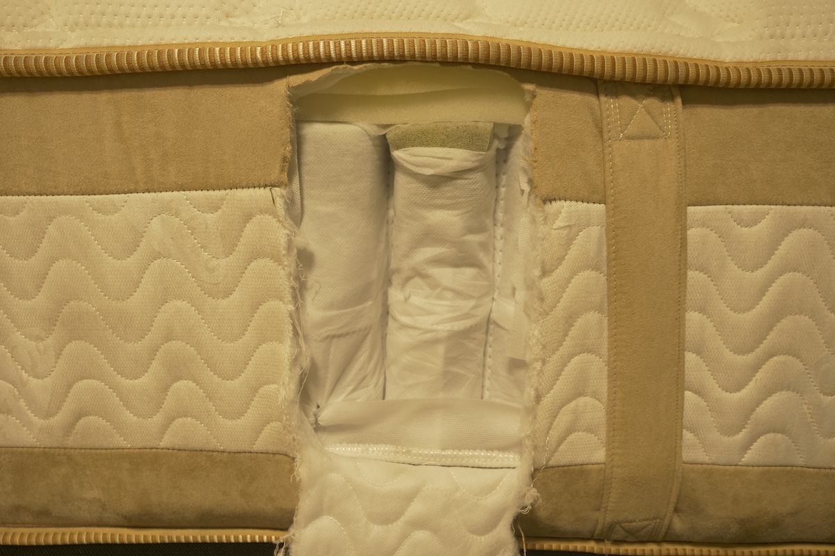 A side-view of the Satva Rx with a portion cutout showing the mattress interior