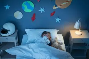 little boy sleeping on his bed
