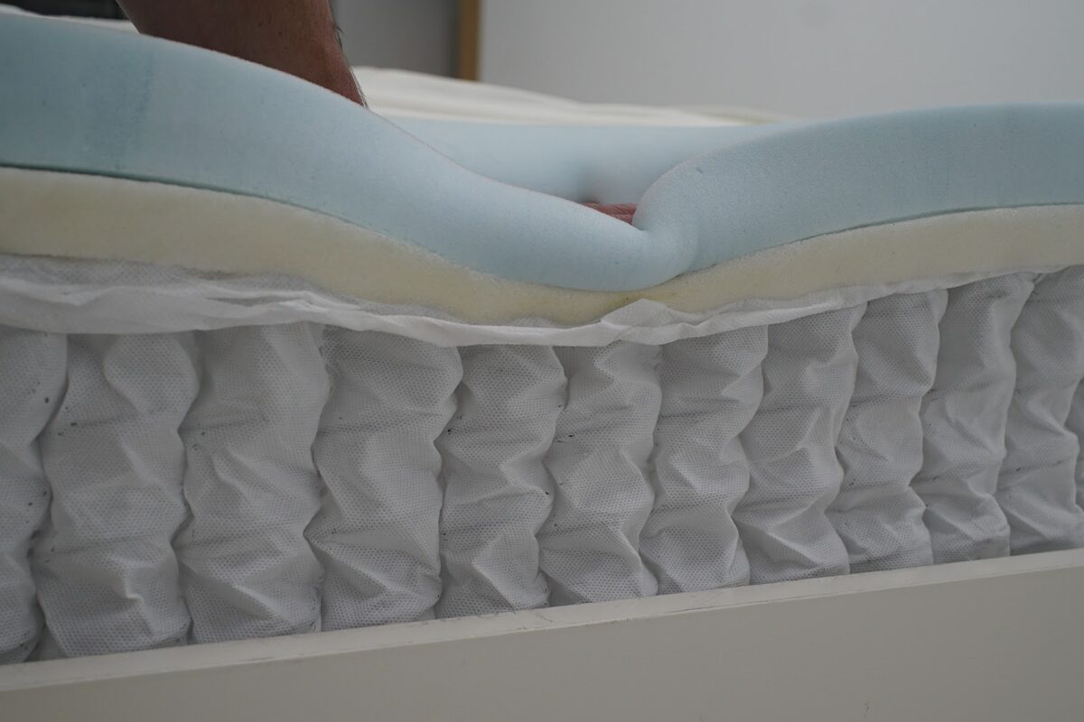 Cross-section cut out of the Helix Sunset mattress to see the strong layer of coils with a supportive layer of memory foam on top.