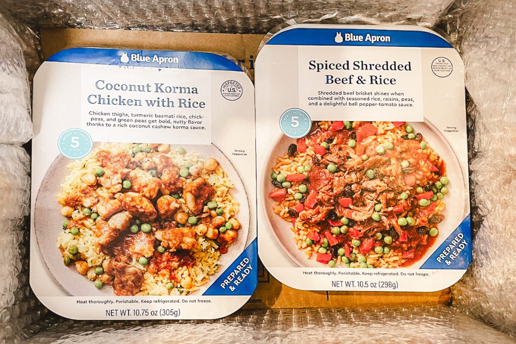 Two Blue Apron meal kits side by side.