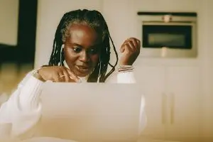 A woman looking at a laptop screen