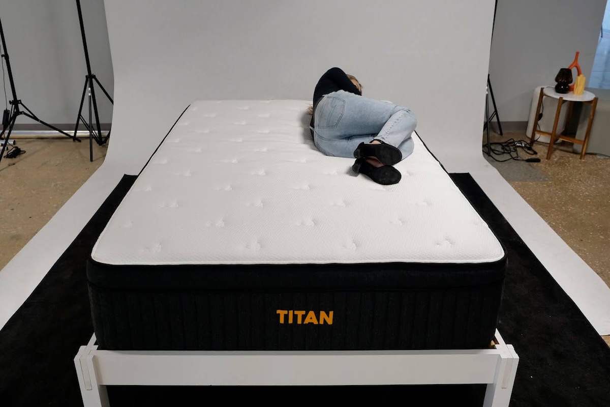 One of our testers lies on the Titan Plus Luxe testing the side-sleeping position.