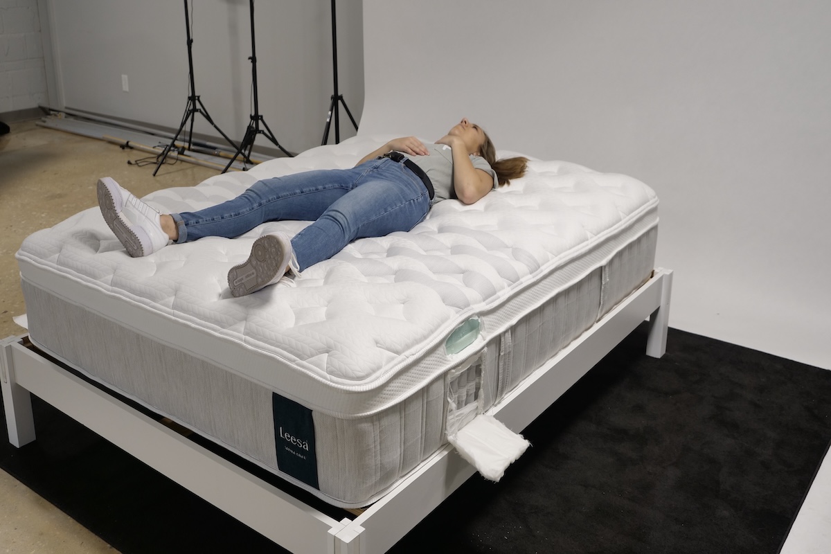 A woman lays on the Leesa Sapira Chill mattress.