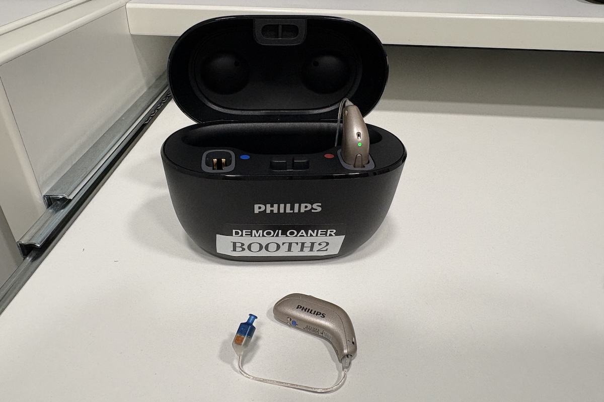 The Philips hearing aids in a case marked Demo/Loaner Booth 2.