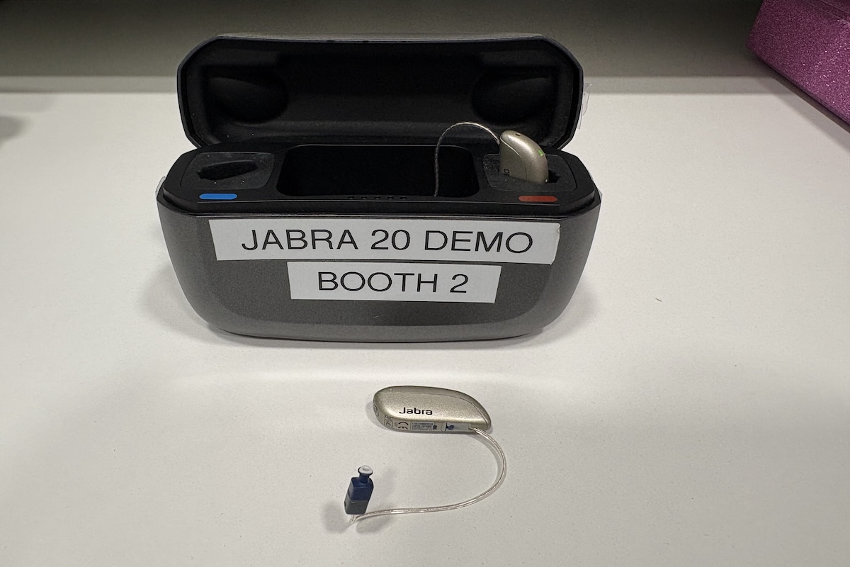 The Jabra Enhance Pro 20 hearing aids in a case labeled Demo Booth 2.